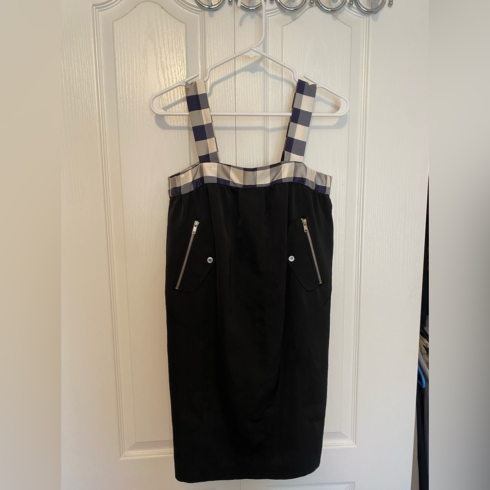 Cropped black mini dress with square neck, pockets and zip details